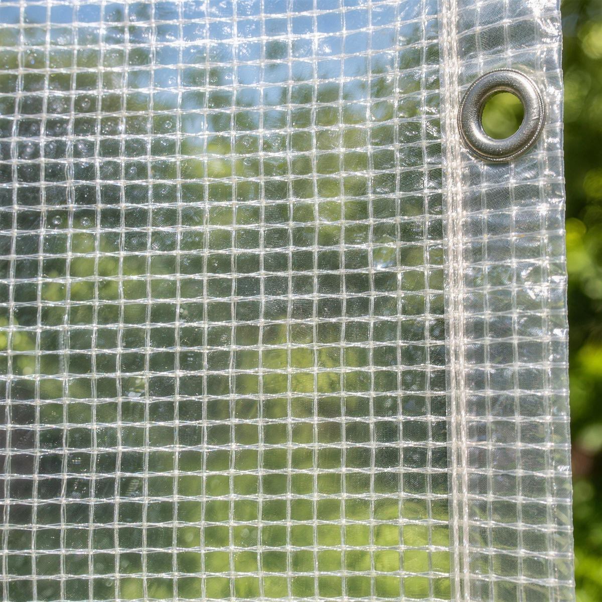 Close-up of the clear mono cover with daylight showing the laminated reinforcing grid and an eyelet