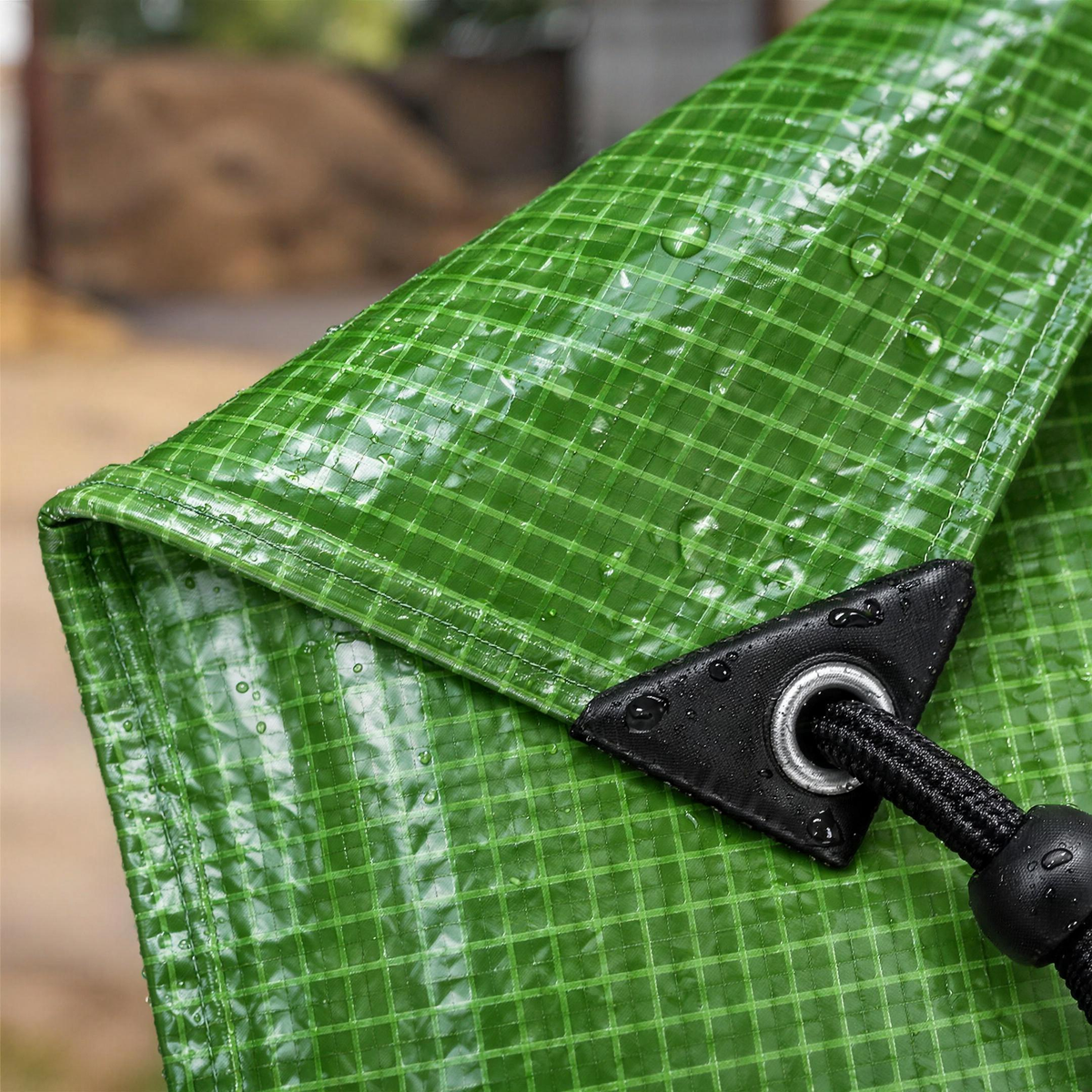 Close-up of the green mono cover grid, black corner patch, eyelet and bungee cord